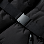 Black puffer jacket zipper with fabric tab and snap detail