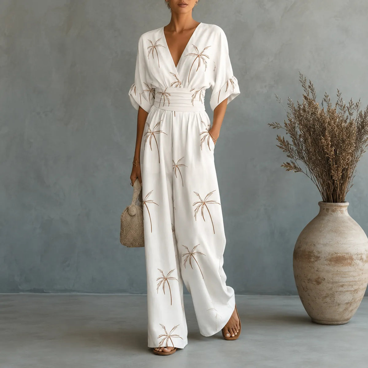 Women's floral V-neck wide-leg jumpsuit with cinched waist and pockets, white.