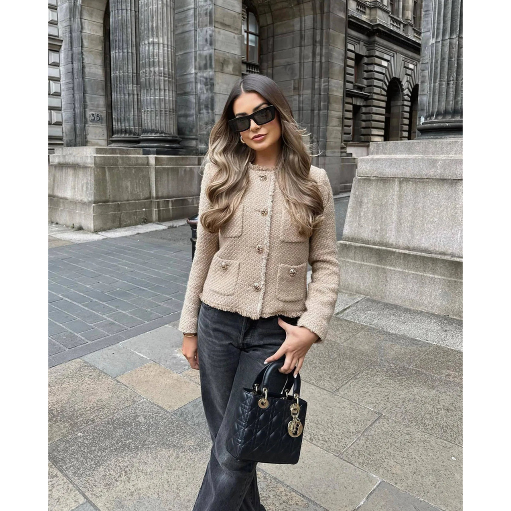 Beige tweed collarless cropped jacket with gold-tone buttons and patch pockets, long sleeves