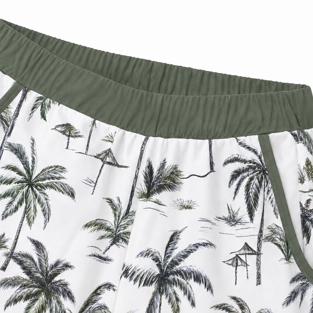 Palm-print swim shorts with green elastic waistband and side trim