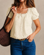 Cream square-neck lace tee with puff sleeves and scalloped eyelet trim