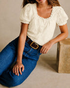Cream square-neck lace blouse with puff sleeves and textured embroidered details