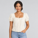 Cream square-neck lace tee on model with puff sleeves, styled with light blue jeans