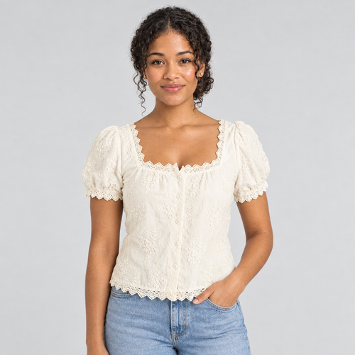 Cream square-neck lace tee on model with puff sleeves, styled with light blue jeans
