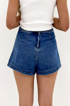 Blue denim mini skort with faux-wrap front, belt loops, and center seam