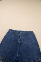 Blue denim mini skort close-up of waistband, zip fly, and front seams