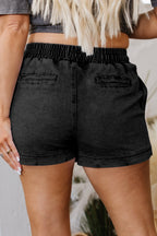 Black denim shorts, elastic waistband with drawstring and side pockets detail.