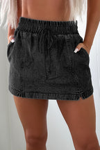 Black denim shorts, back view with elastic waistband and drawstring, denim pockets.