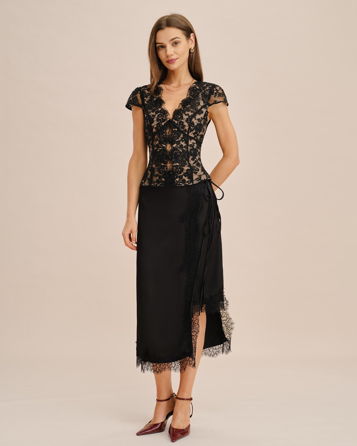 Black lace V-neck blouse with short sleeves and side tie detail at waist