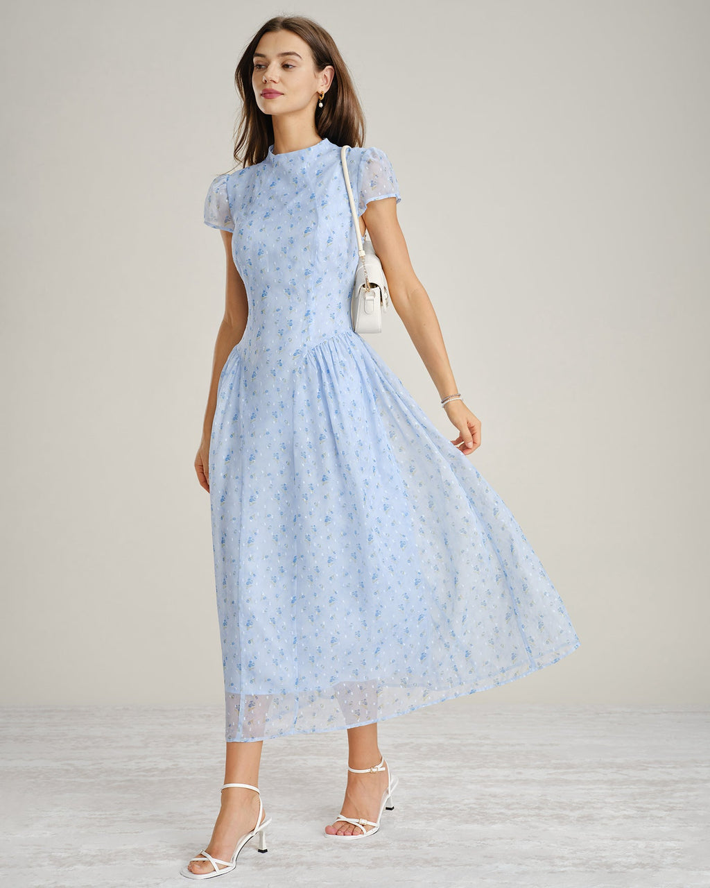 Blue floral chiffon maxi dress with mock neck and short sleeves, flowing gathered skirt