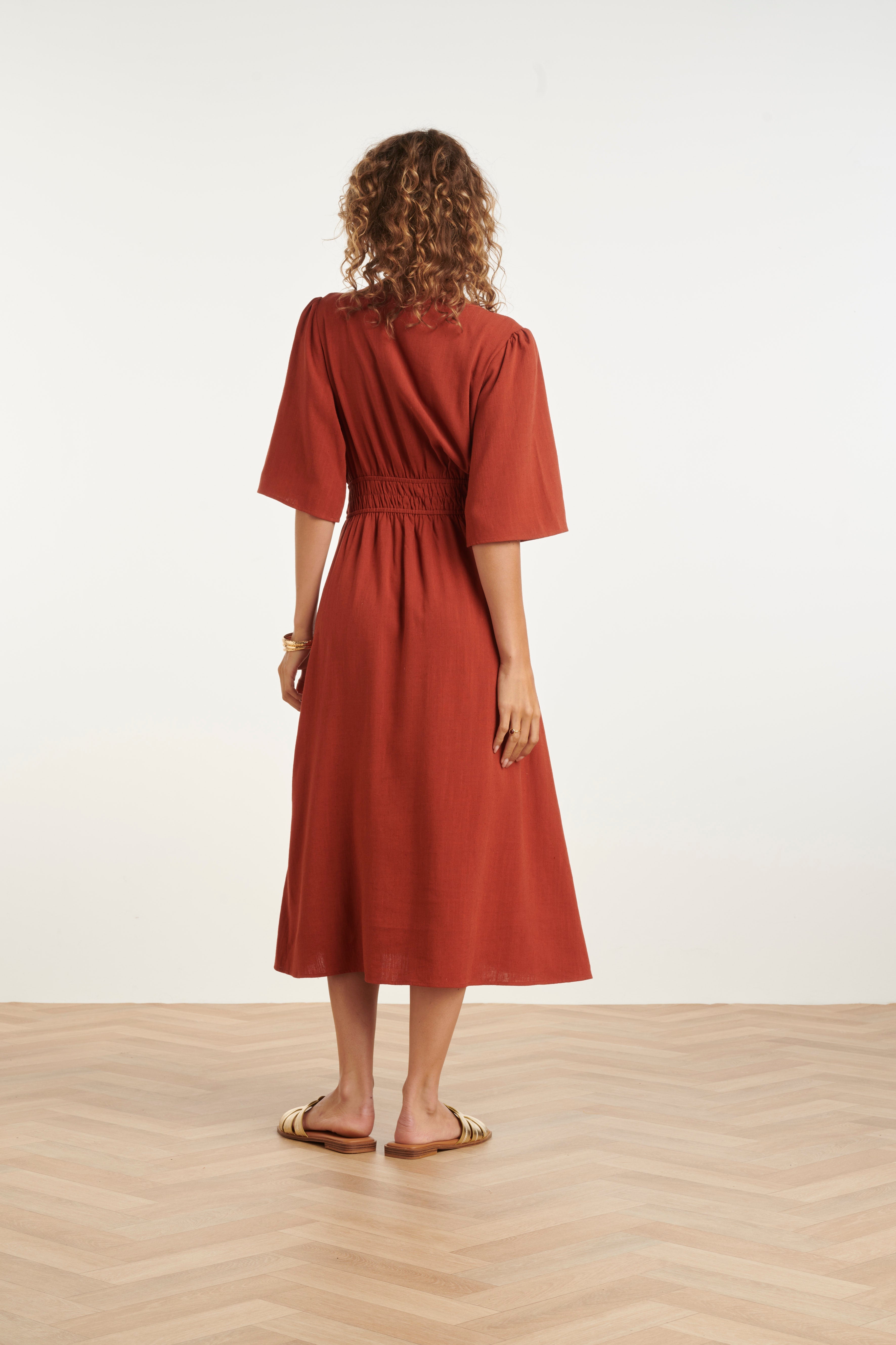 Brick midi dress back view with elastic waist and elbow-length sleeves