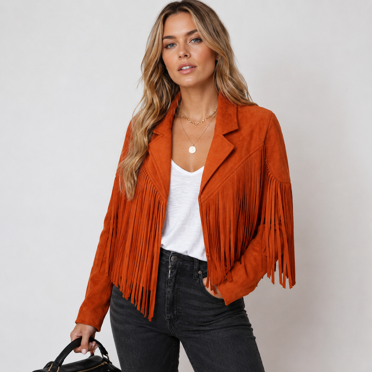 Orange cropped faux suede fringe jacket with notched collar and tassel trim