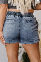 Dusk blue denim shorts with elastic waistband and two front pockets, back view