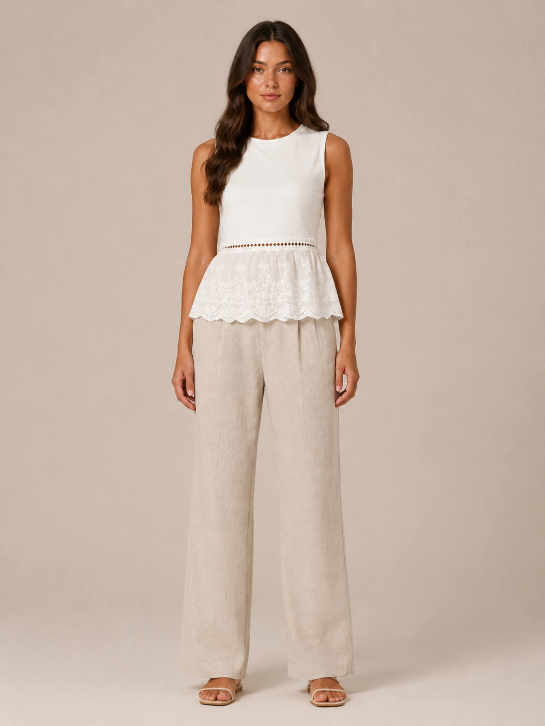 Women's white lace peplum tank top with embroidered hem and beige wide-leg linen pants