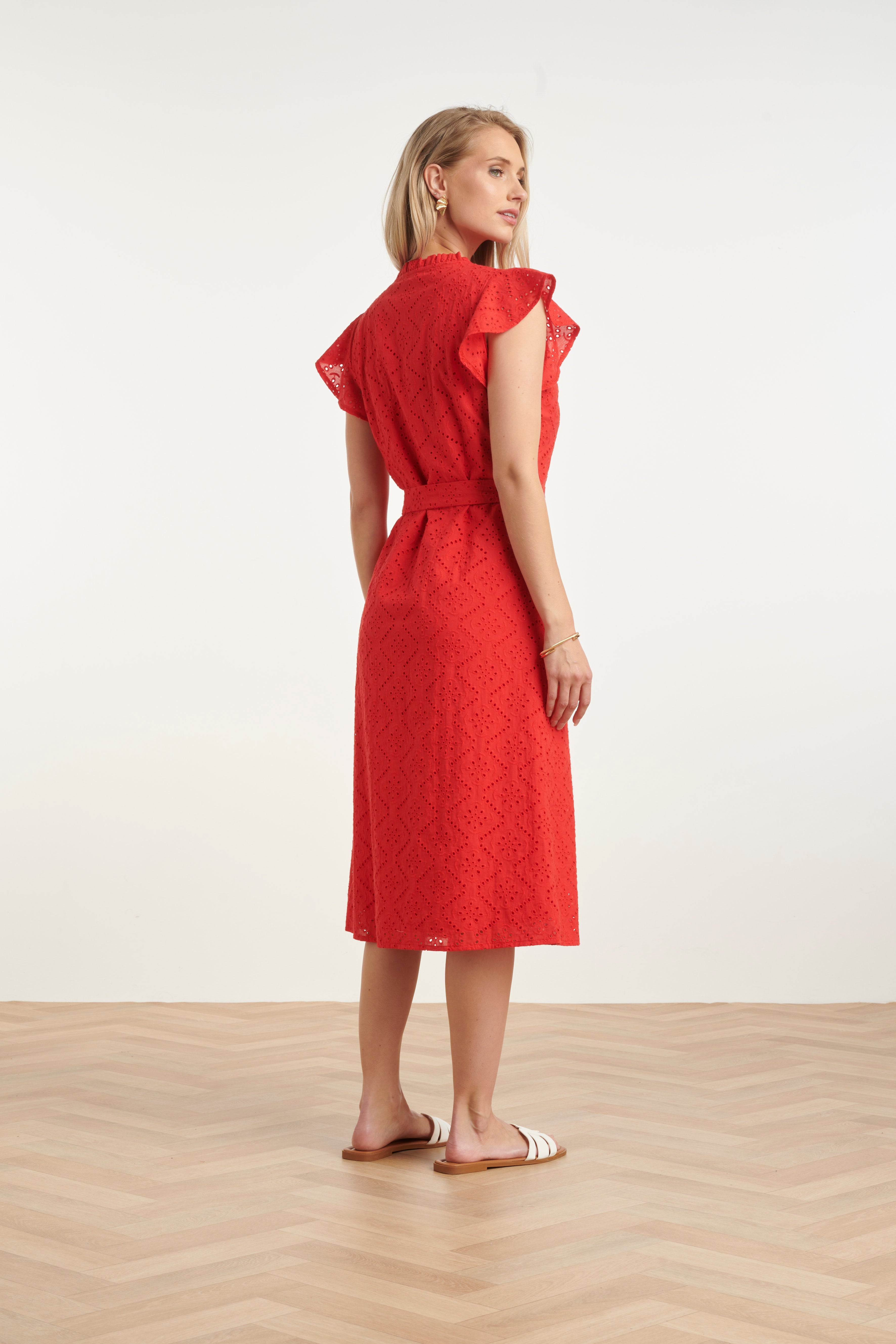 Red women's midi dress, flutter sleeves, belted waist, geometric embroidery, side view