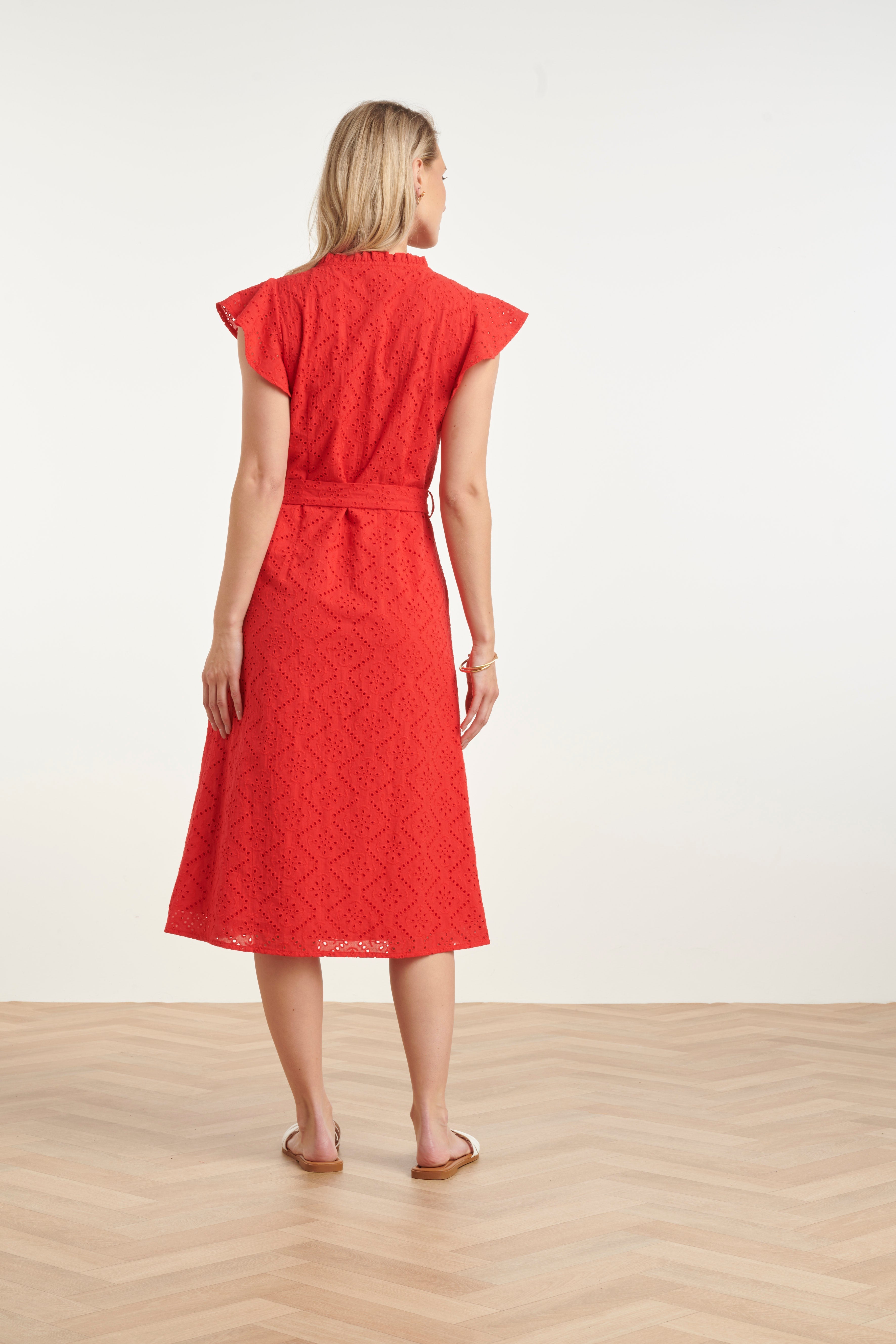 Red women's midi dress back view with flutter sleeves, geometric embroidery and tie belt