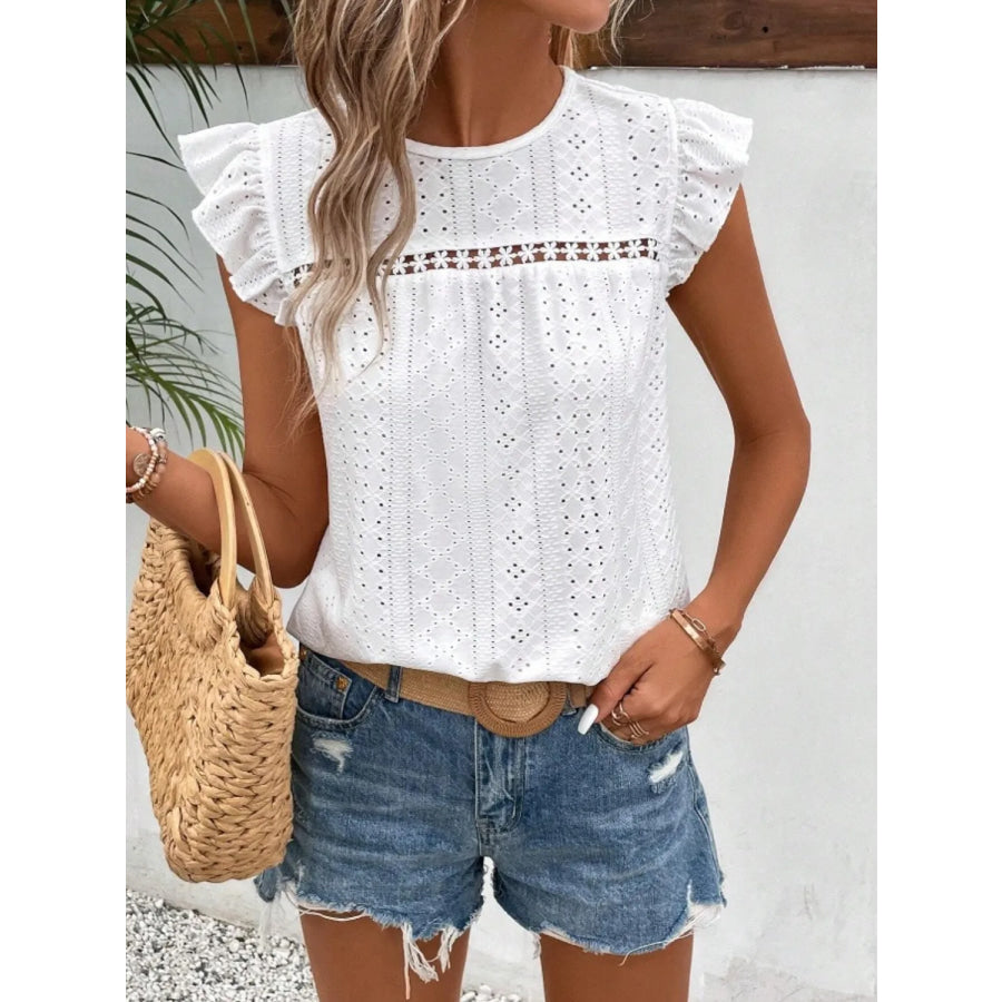 Women's eyelet cap-sleeve blouse in white with all-over eyelet pattern and round neck