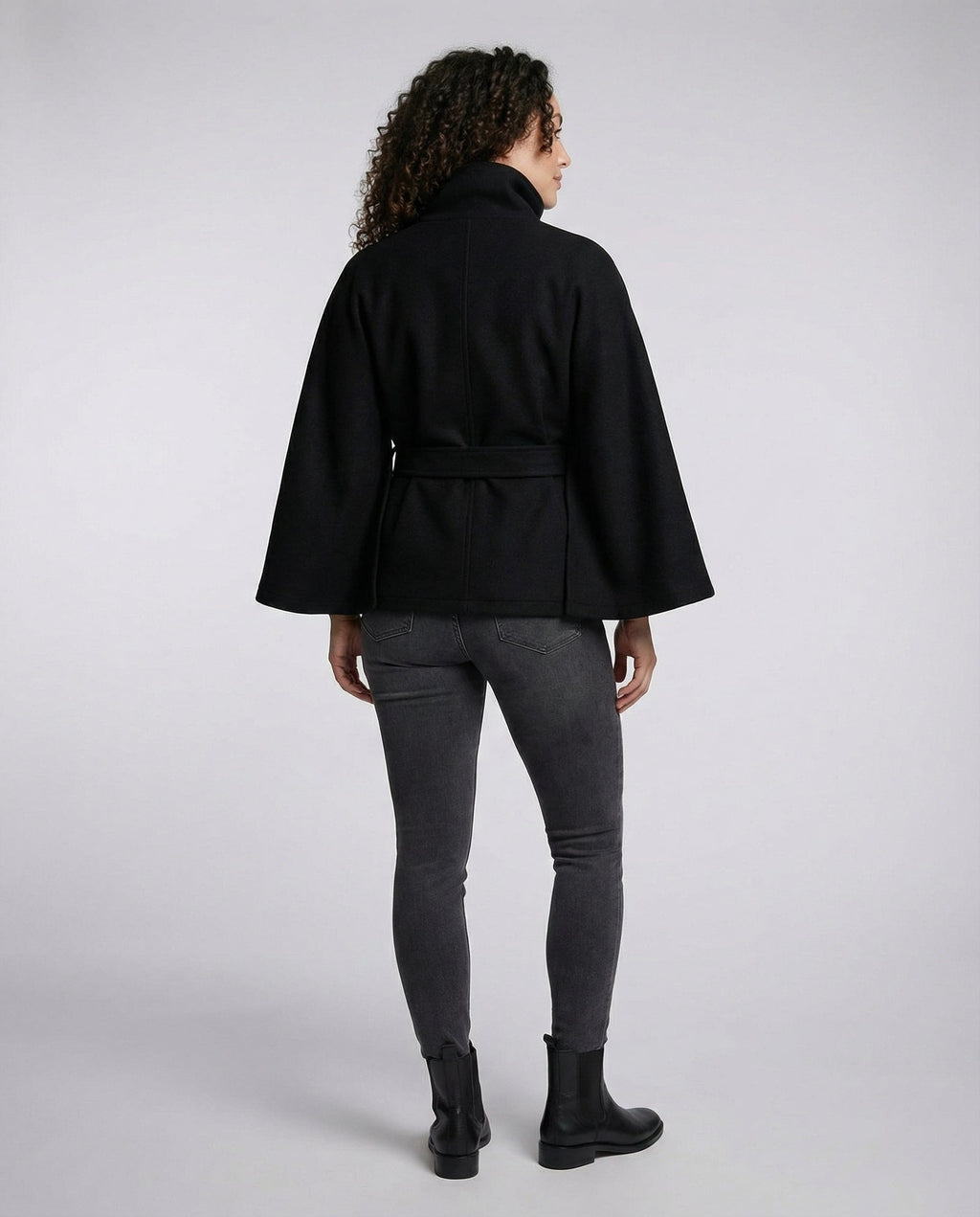 Women's wrap coat back view, black high collar with waist tie belt