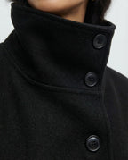 Women's wrap coat collar close-up with button placket, black