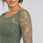 Sage green sheer floral lace sleeve detail on model