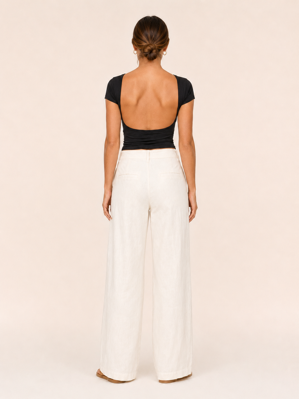Black short-sleeve crop top with open-back cutout and round neckline