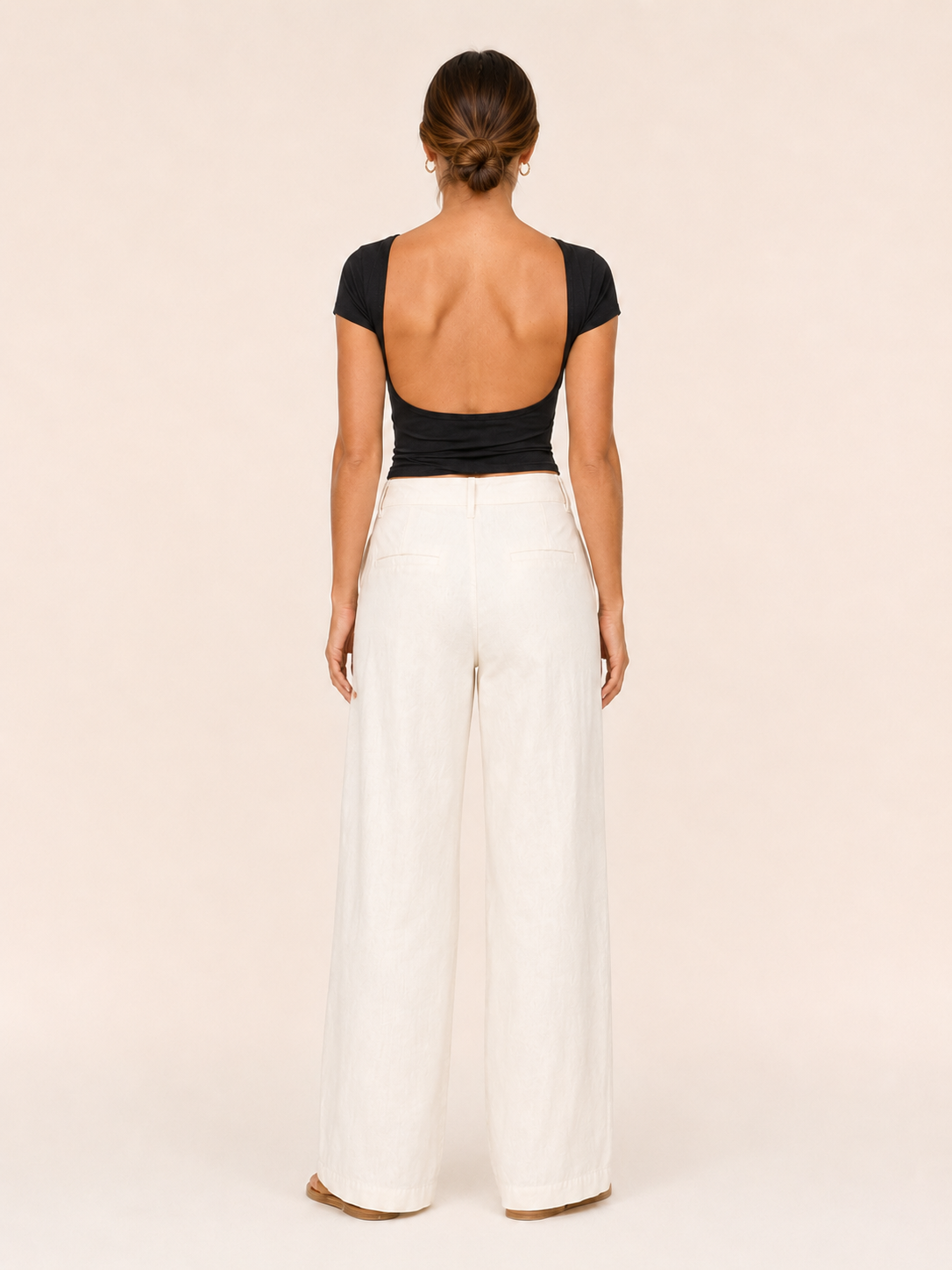 Black short-sleeve crop top with open-back cutout and round neckline