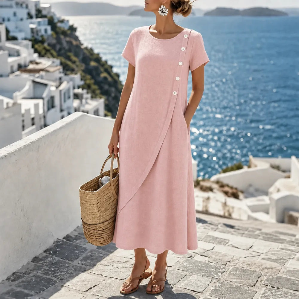 Women's asymmetrical button midi dress, blush pink, short sleeves and flowing overlay.