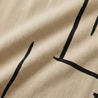Beige fabric close-up with black abstract line pattern