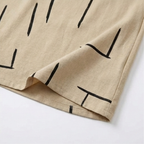 Beige shift dress hem with black abstract line print and neat stitching