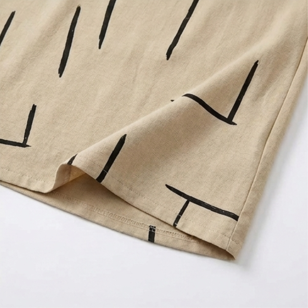 Beige shift dress hem with black abstract line print and neat stitching