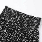 Black smocked wide-leg trousers with white tiny flower print and elastic waistband