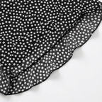 Black trousers with a ruffle hem and white tiny flower dot print
