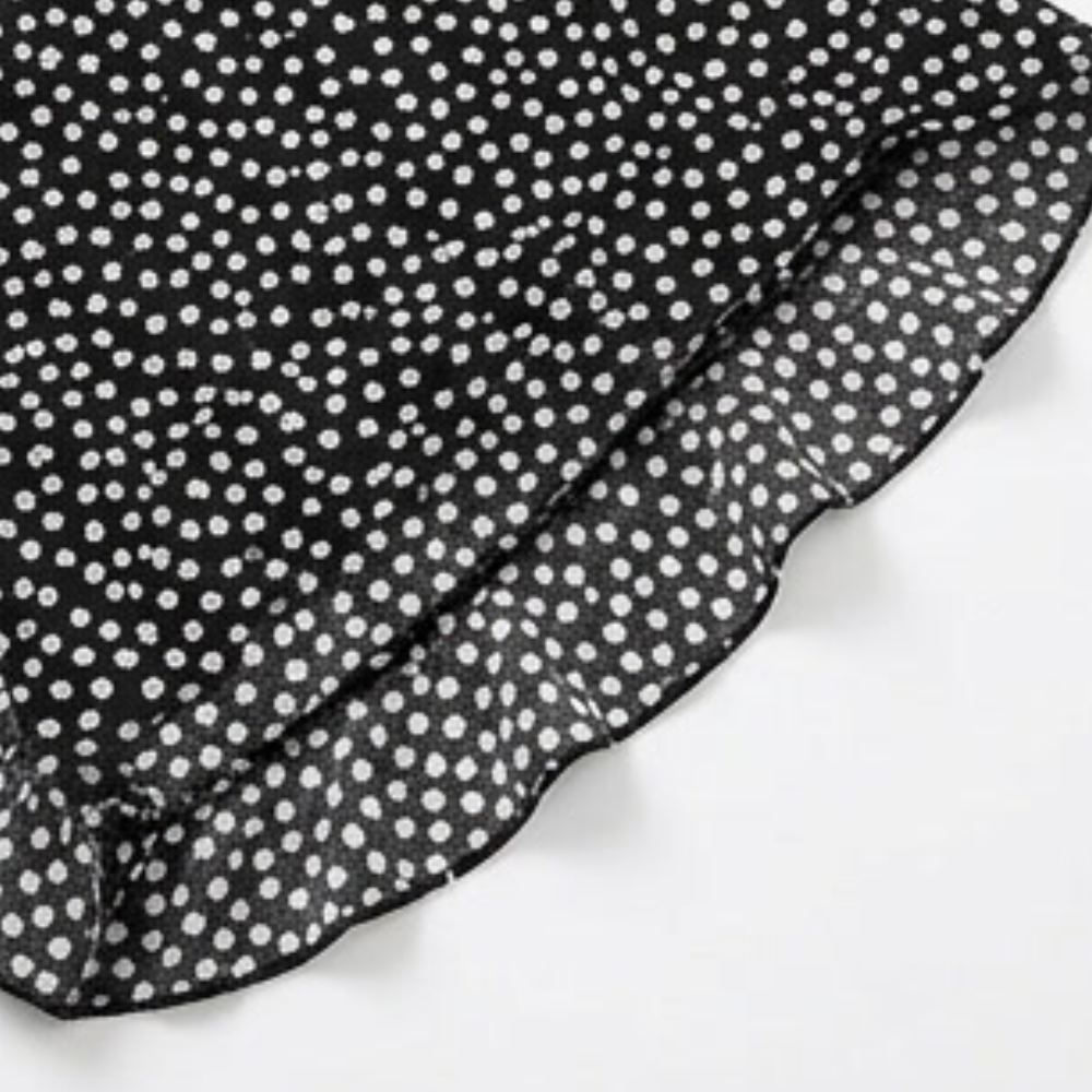 Black trousers with a ruffle hem and white tiny flower dot print