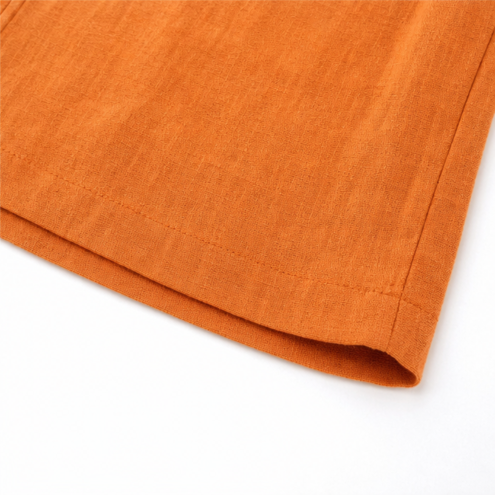 Orange linen-look shorts hem with soft drape finish