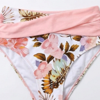 Floral high-waisted bikini bottoms with pink trim and matching waistband, close-up