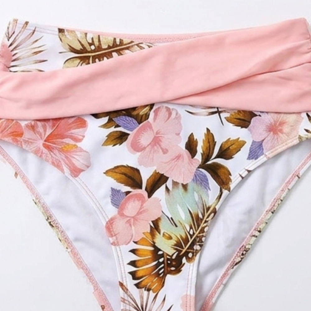 Floral high-waisted bikini bottoms with pink trim and matching waistband, close-up
