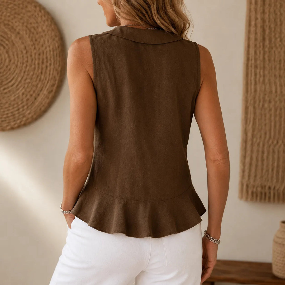 Dark brown sleeveless peplum blouse with flared hem