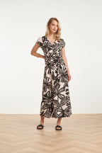 Women's black maxi dress with off-white leaf print and waist tie detail, wrap V-neck