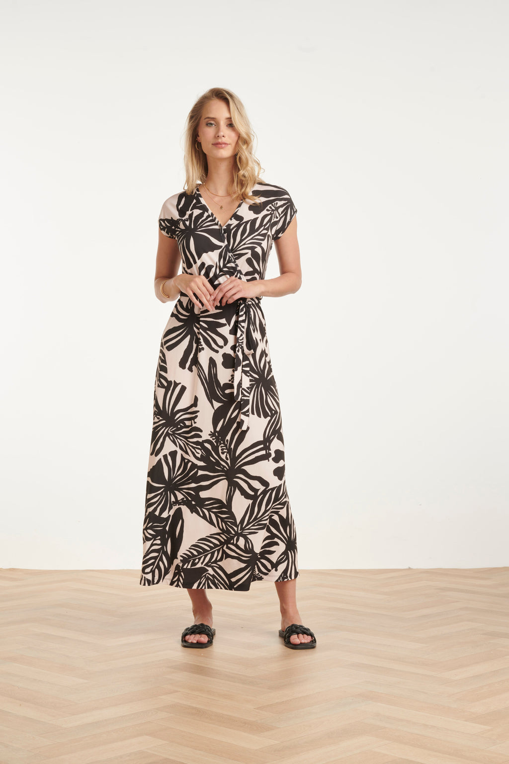Women's black maxi dress with off-white leaf print, wrap V-neck and gathered waist tie