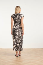 Women's black maxi dress with off-white leaf print, back with fitted waist and tie