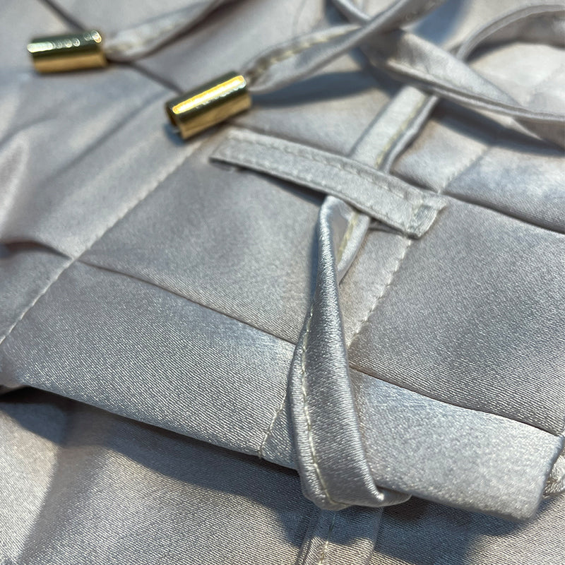 Metallic-look satin fabric with matching belt tie and long pleated pant panel