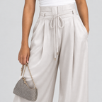 Champagne high-waist pleated trousers detail with drawstring tie and silver bag