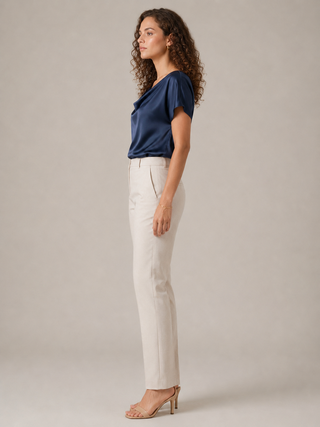 Navy draped-neck blouse with short sleeves, side view