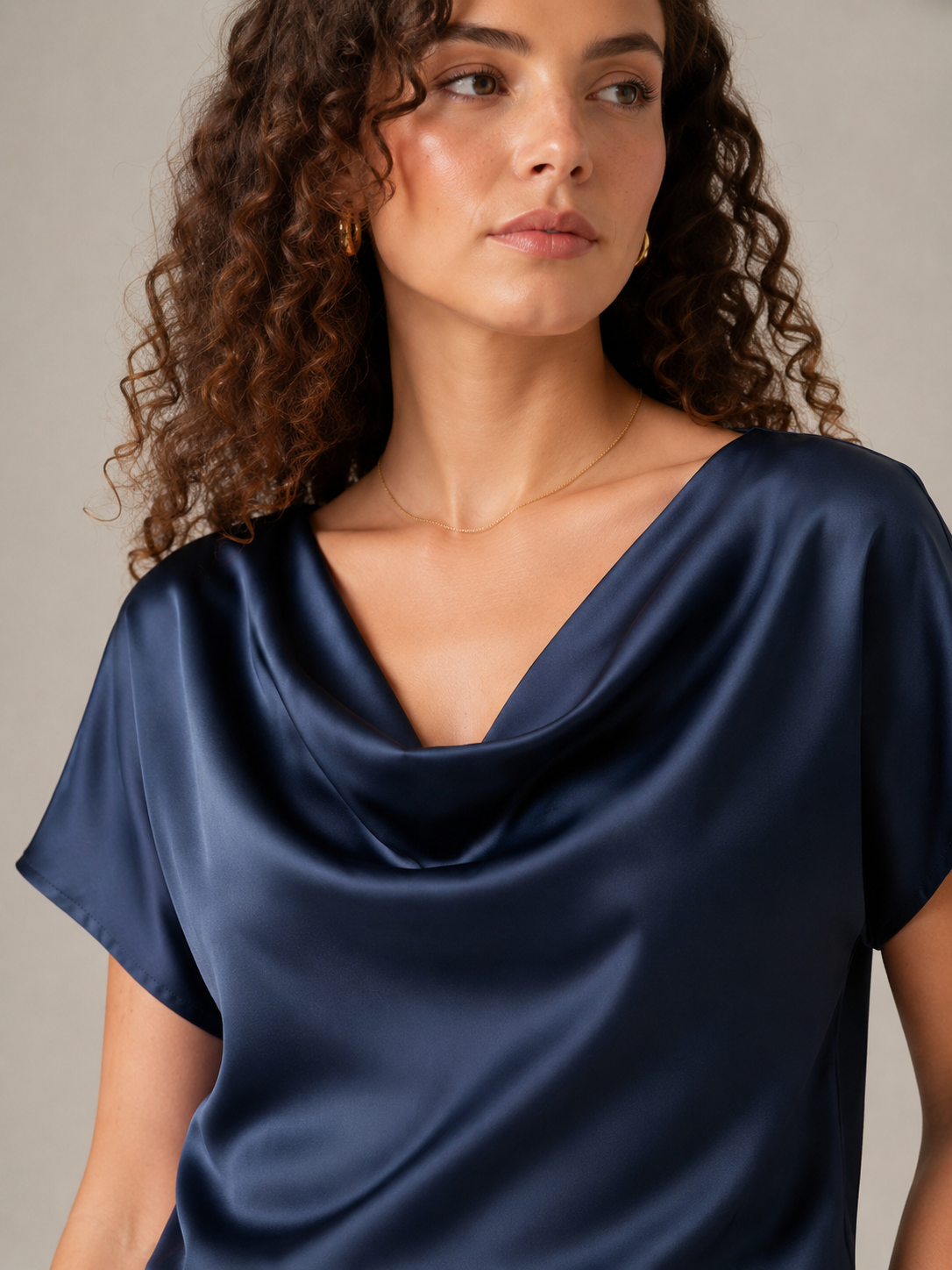 Close-up of navy draped neckline on a short-sleeve blouse