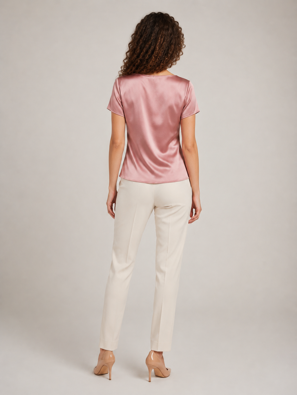 Pink short-sleeve draped-neck blouse shown from the back