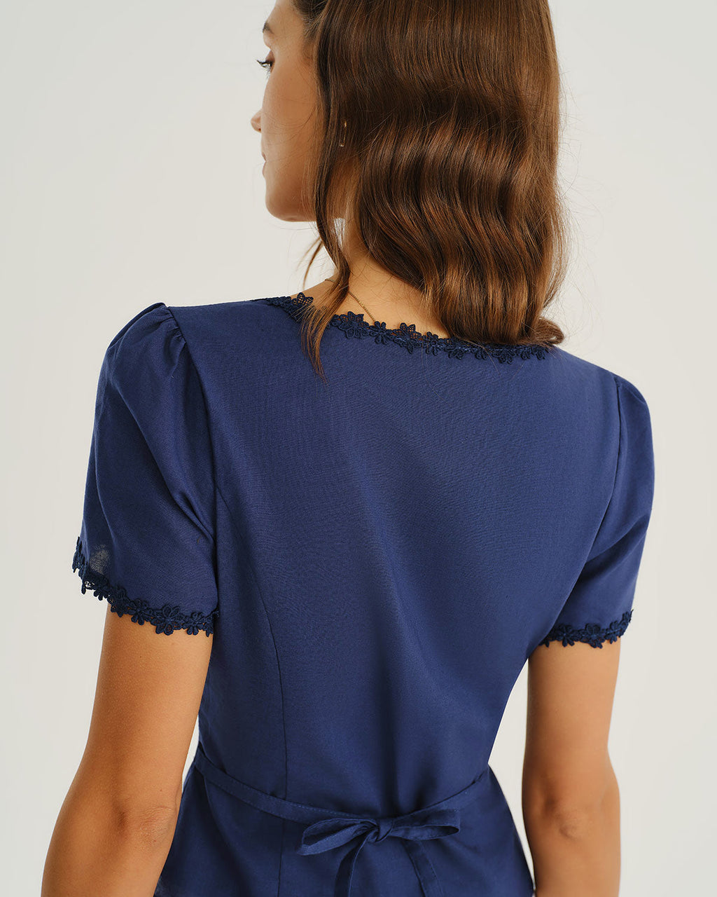 Navy blouse back with lace-trim square yoke and short cuffed sleeves
