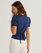 Navy blouse back with lace-trim neckline and waist tie at center
