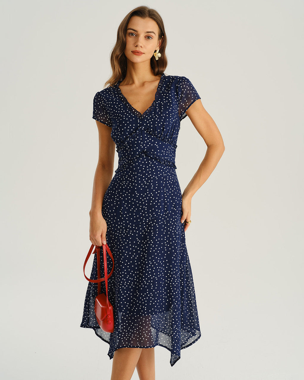 Navy blue wrap midi dress with cap sleeves and scattered white dot pattern