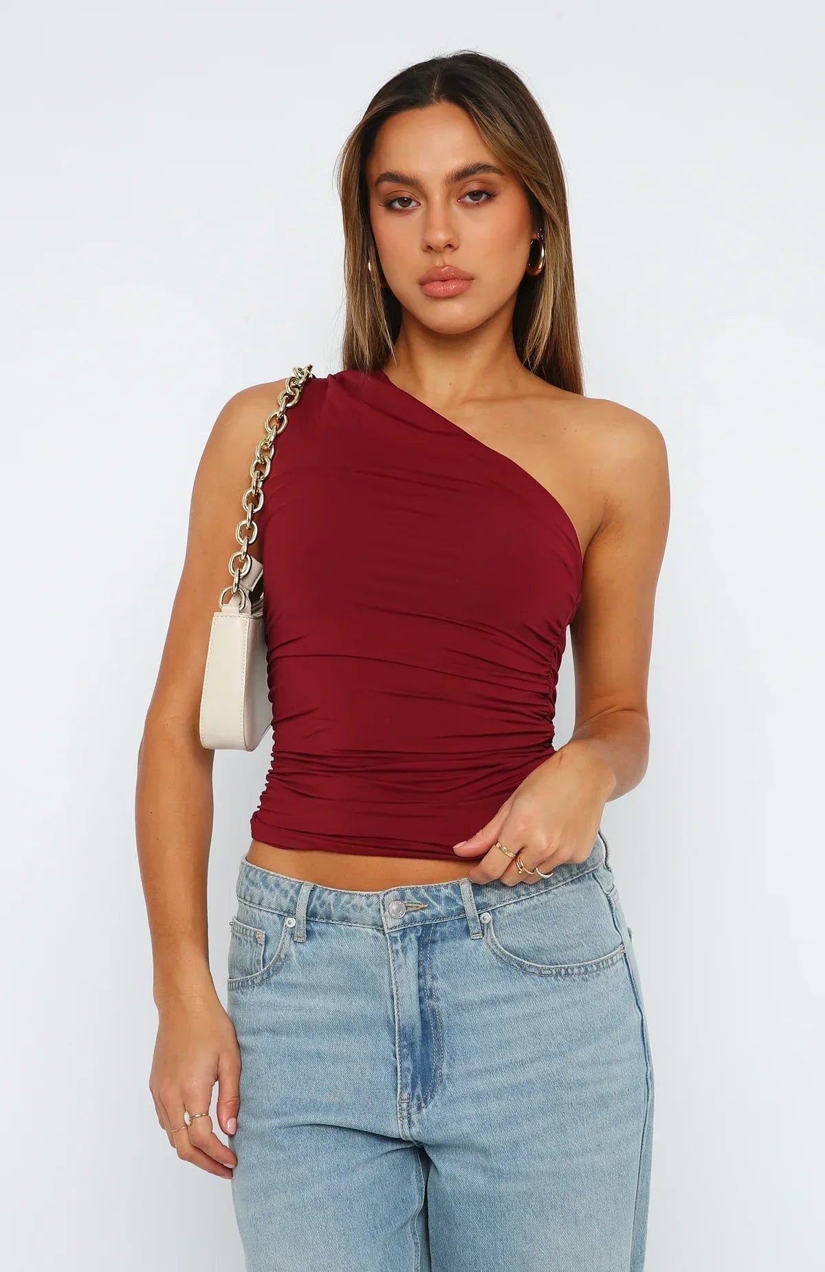 Ruched one-shoulder stretch top, burgundy red, fitted silhouette, draped waist