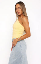Ruched one-shoulder stretch top, pale yellow, fitted silhouette, draped waist